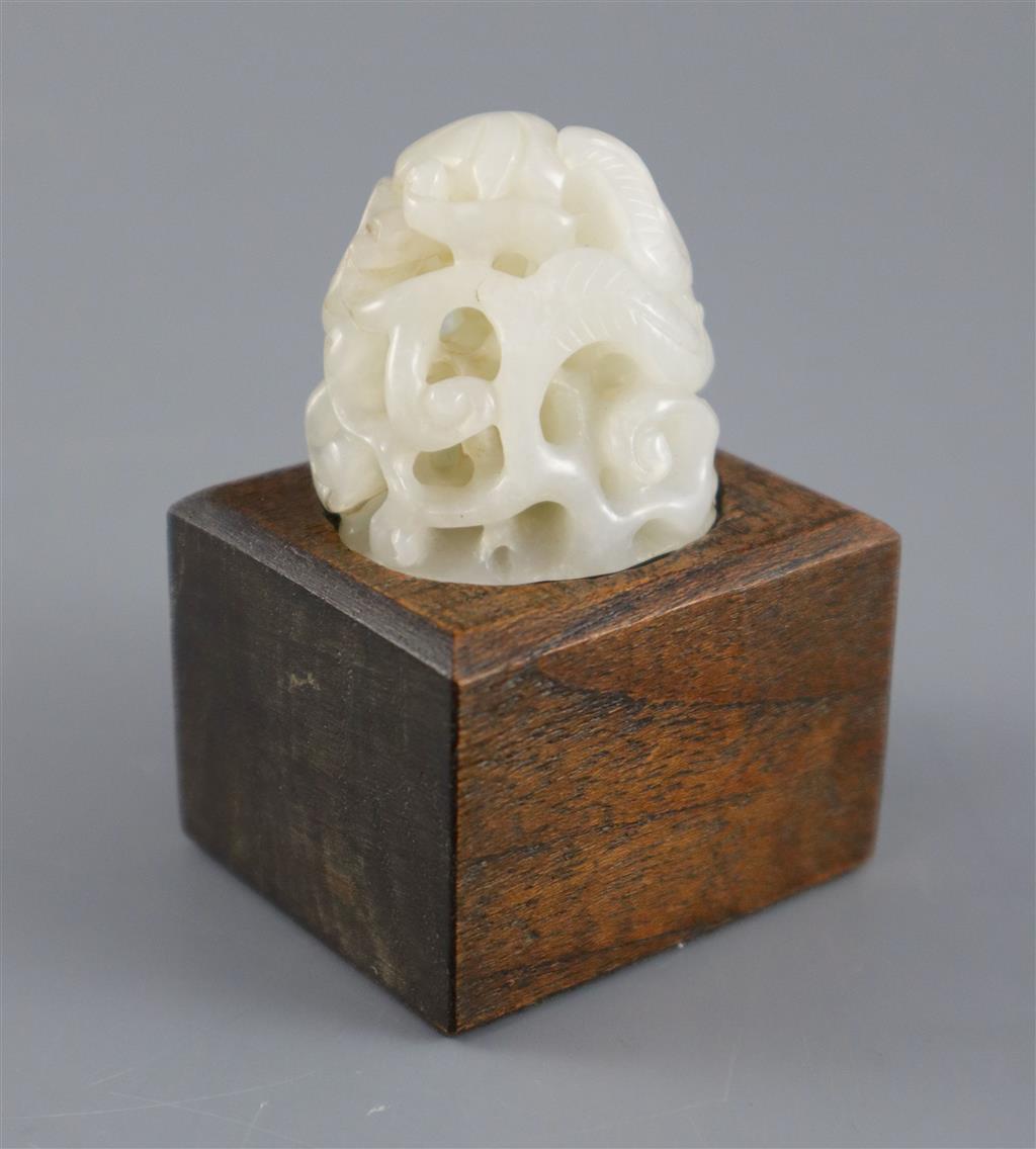 A Chinese white jade hat finial, 3.8cm high, later wood stand